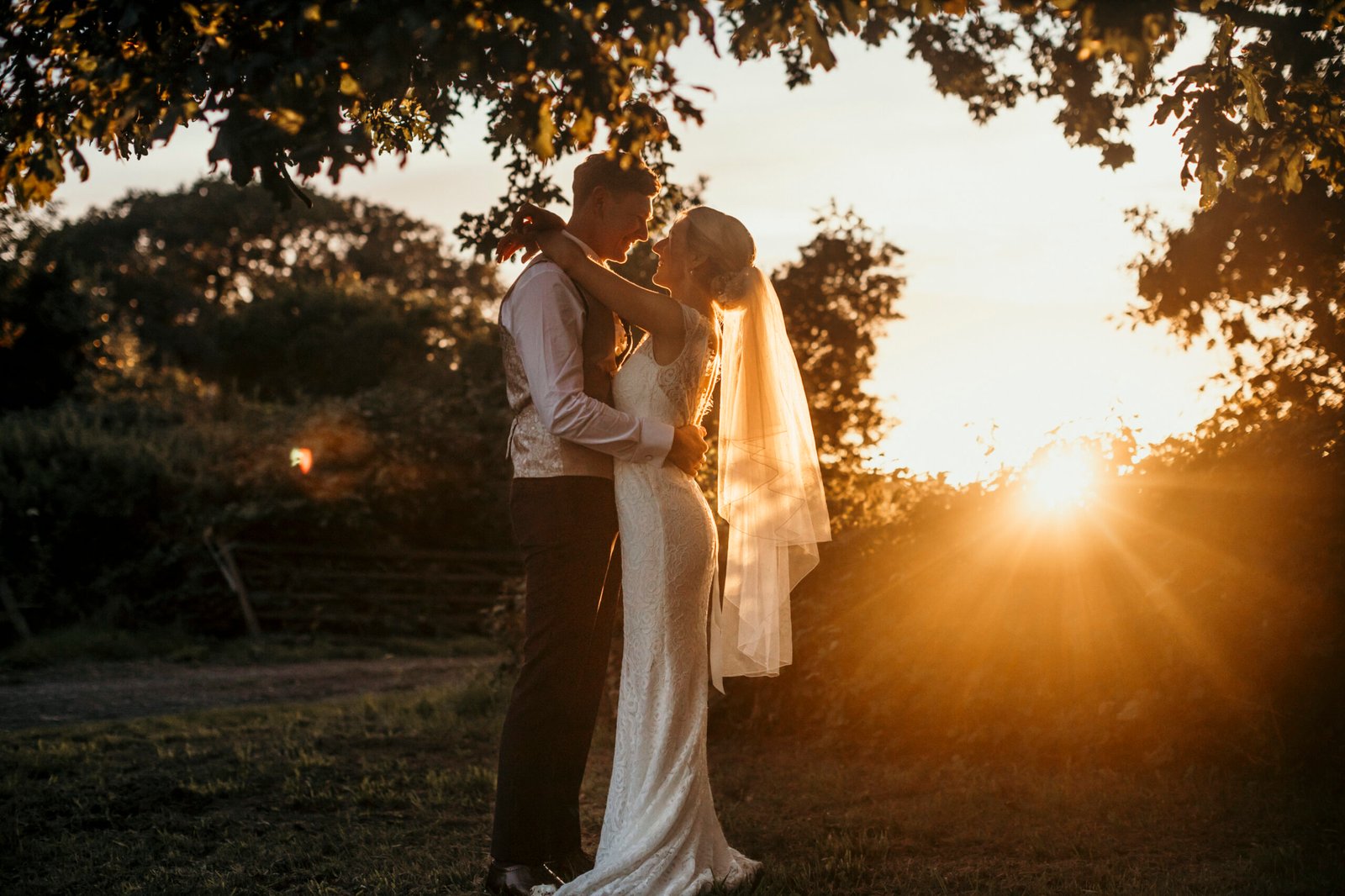 couple enjoying the sunset on their wedding evening