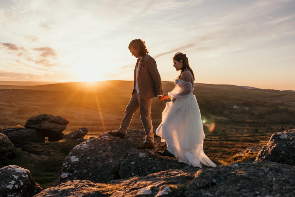 wedding couple walking on dartmoor at sunset