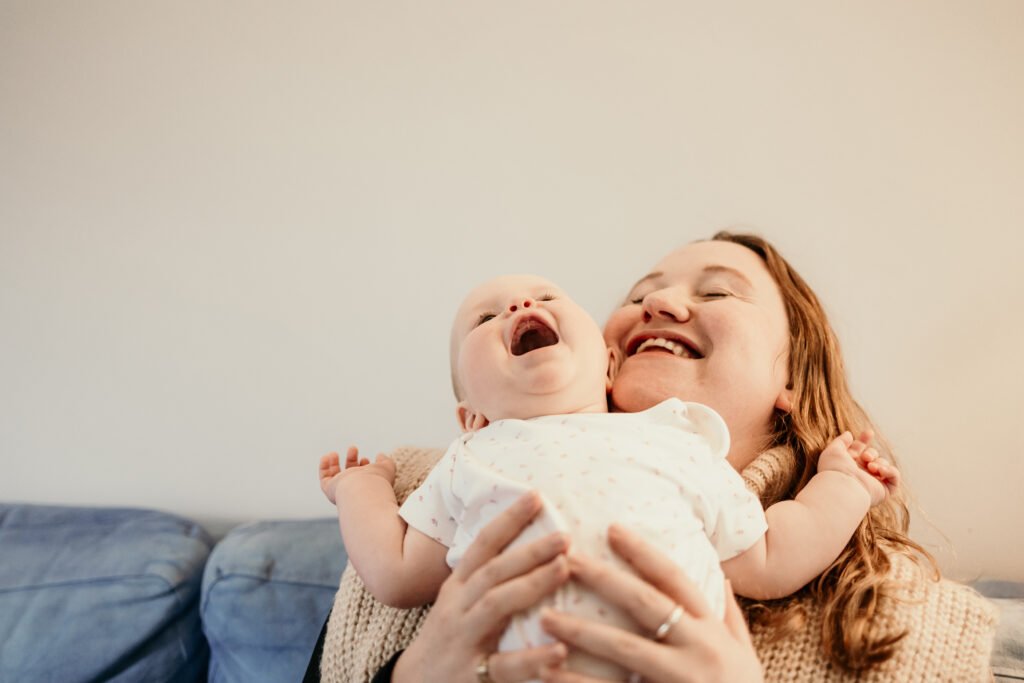 baby laughing with mum