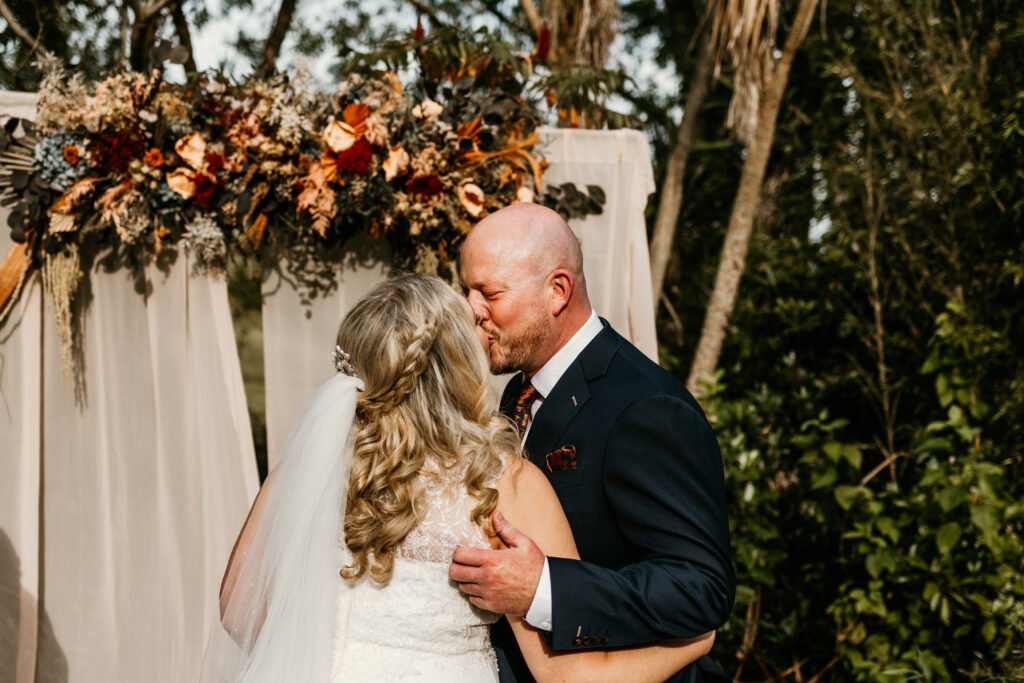 A first  kiss at the outdoor ceremony