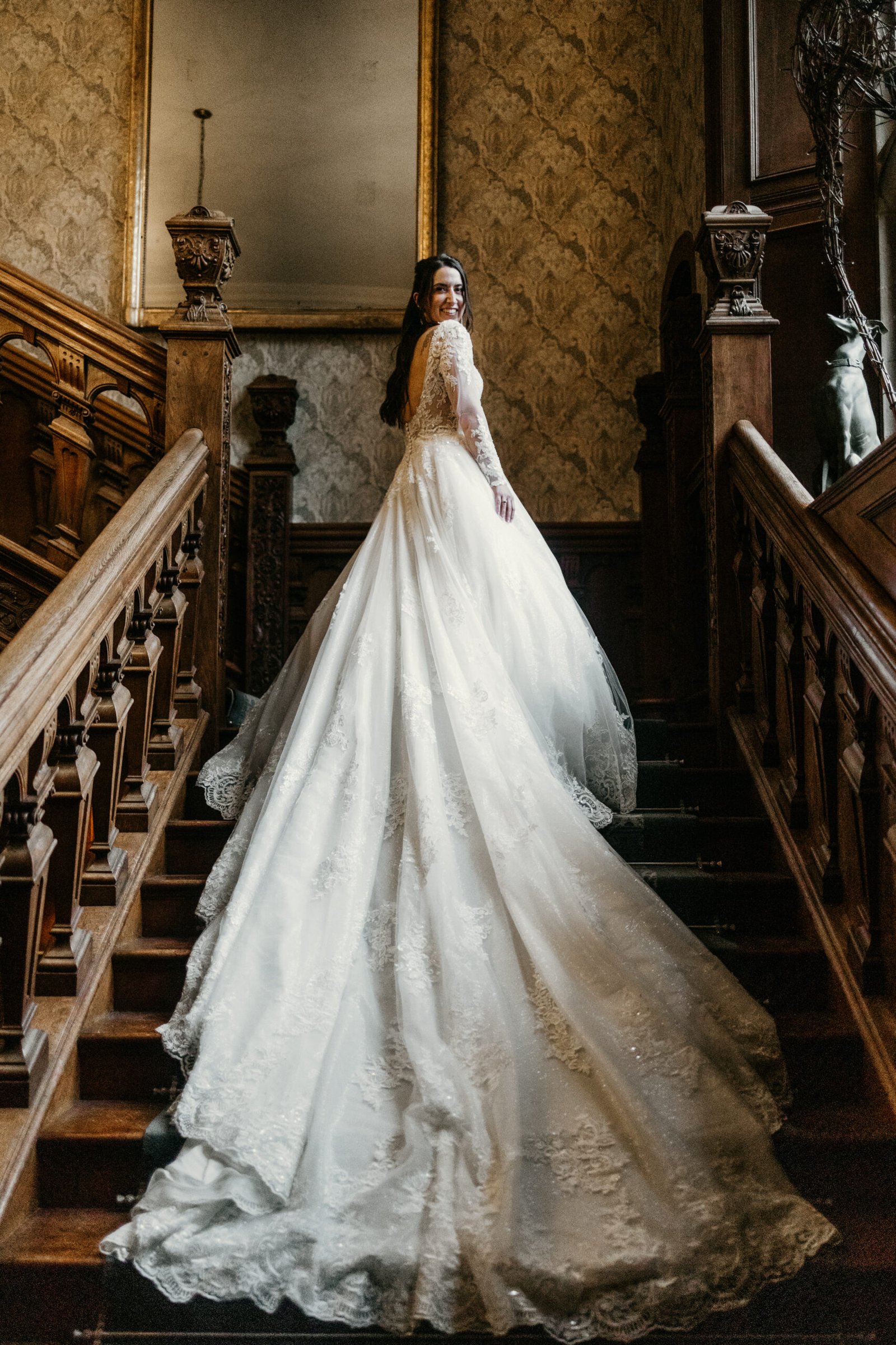 bride with very long dress train on staircase